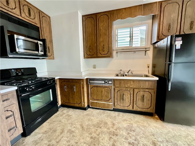 kitchen featuring dishwasher, black gas stove, fridge, and sink