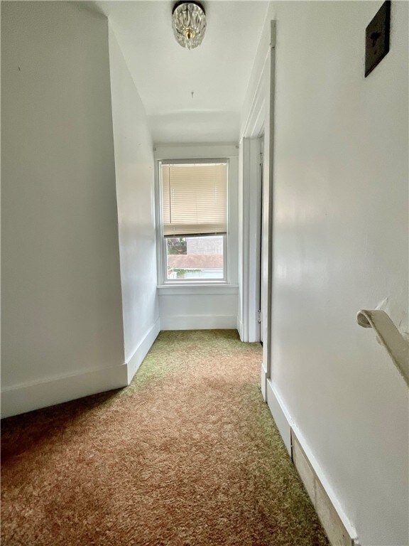 corridor with light colored carpet