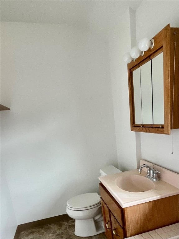 bathroom featuring tile patterned floors, toilet, and sink