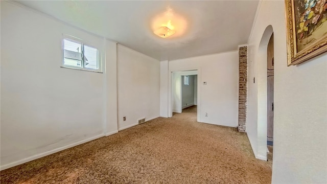 unfurnished room with crown molding and light colored carpet