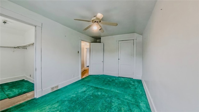 unfurnished bedroom featuring hardwood / wood-style floors, ceiling fan, and a closet