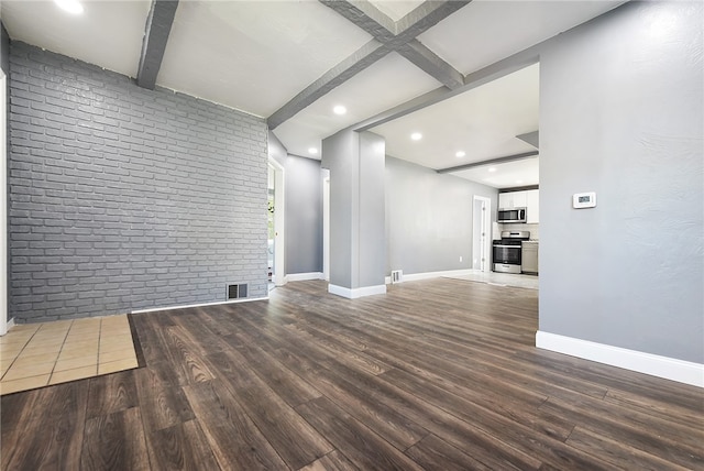 unfurnished living room with beam ceiling, brick wall, and hardwood / wood-style flooring