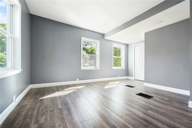 spare room featuring dark hardwood / wood-style flooring