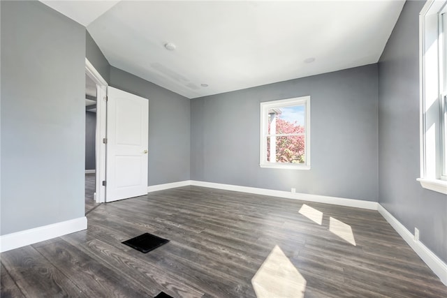 spare room featuring dark hardwood / wood-style flooring