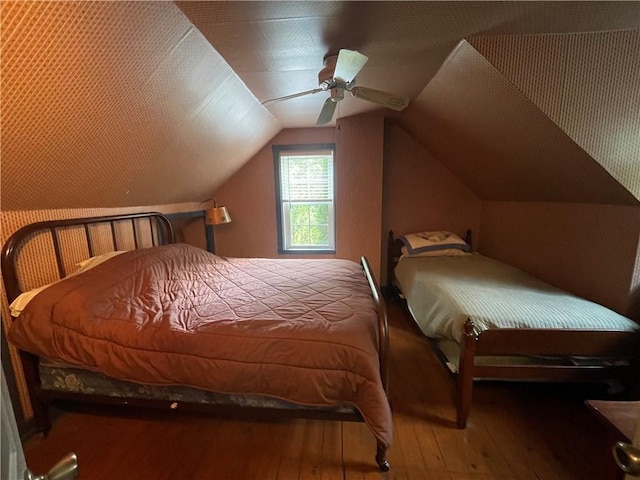 bedroom with hardwood / wood-style floors, ceiling fan, and lofted ceiling