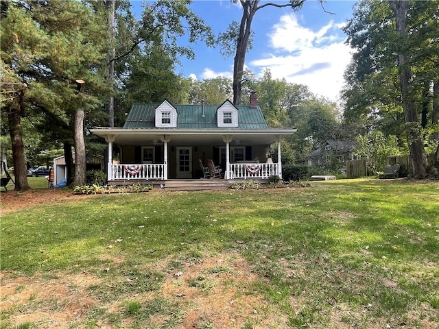 rear view of house featuring covered porch and a yard