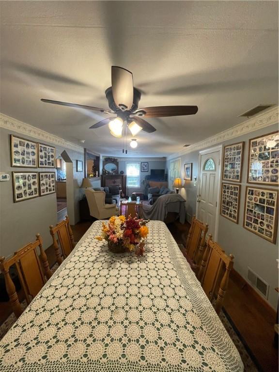 dining room with ceiling fan and crown molding