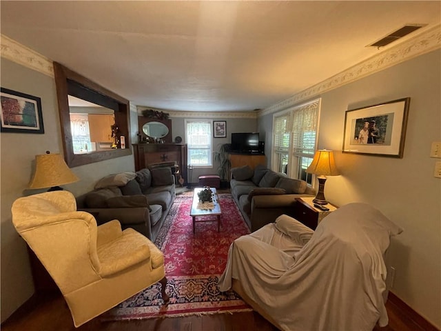 living room with hardwood / wood-style floors and crown molding