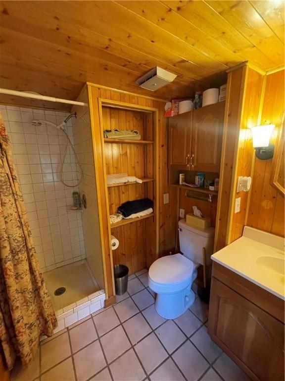 bathroom featuring walk in shower, wood ceiling, vanity, tile patterned flooring, and toilet