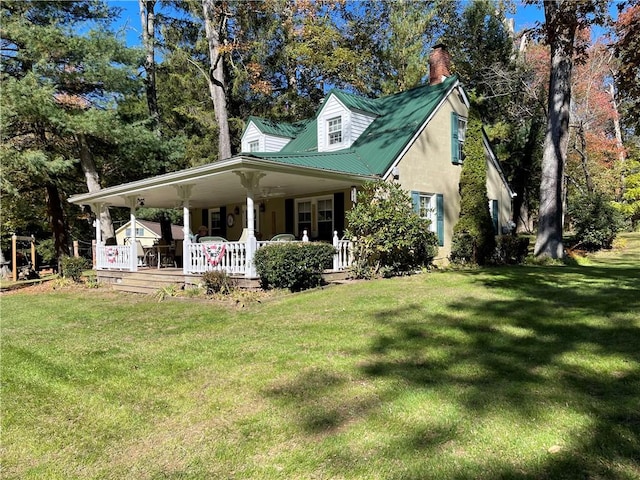 view of front of house with a porch and a front yard