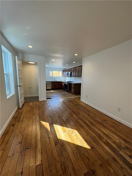 unfurnished living room featuring dark hardwood / wood-style floors