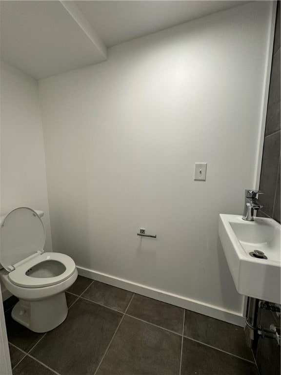 bathroom featuring toilet and tile patterned floors