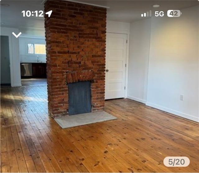 unfurnished living room with wood-type flooring and a fireplace