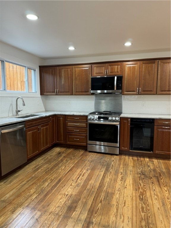 kitchen featuring stainless steel appliances, tasteful backsplash, and dark hardwood / wood-style flooring