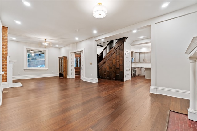 unfurnished living room with dark hardwood / wood-style flooring