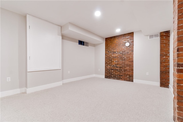 basement with brick wall and carpet flooring