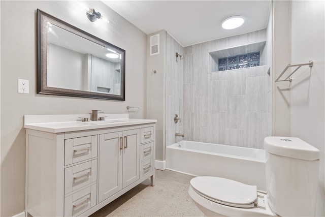 full bathroom with tiled shower / bath combo, vanity, and toilet