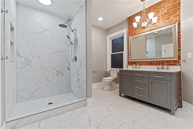 bathroom with a tile shower, vanity, toilet, and a notable chandelier