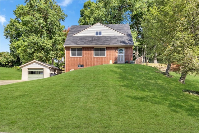 view of front of property with an outbuilding, a garage, and a front yard