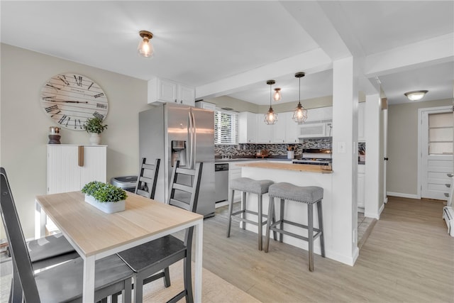 dining room with light wood-type flooring