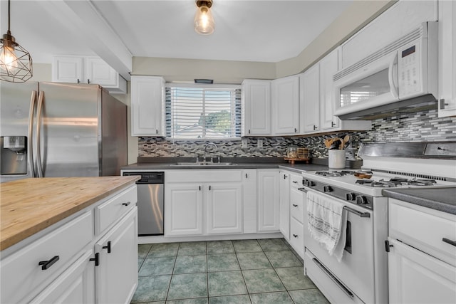 kitchen featuring decorative backsplash, stainless steel appliances, white cabinets, and sink