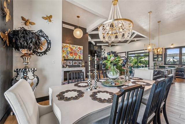 dining area with light wood-type flooring, beam ceiling, and a chandelier