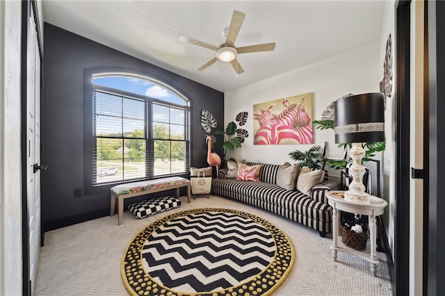 living area with ceiling fan and light colored carpet