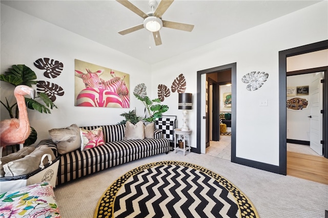 living room with light hardwood / wood-style floors and ceiling fan