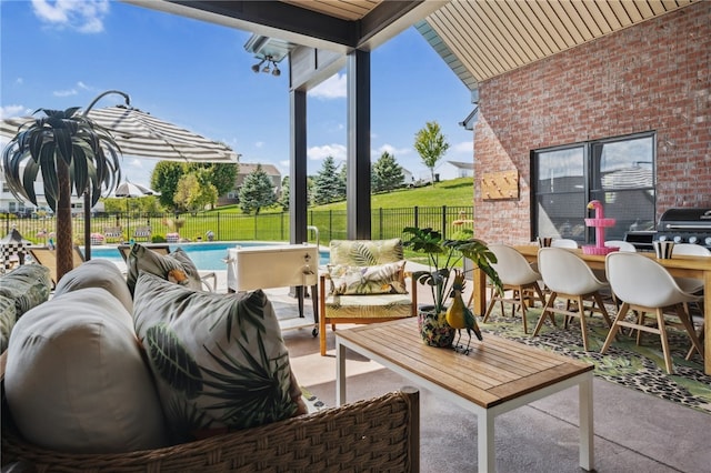 view of patio featuring an outdoor hangout area, a fenced in pool, and a grill