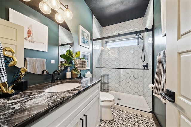 bathroom featuring walk in shower, vanity, toilet, and tile patterned floors