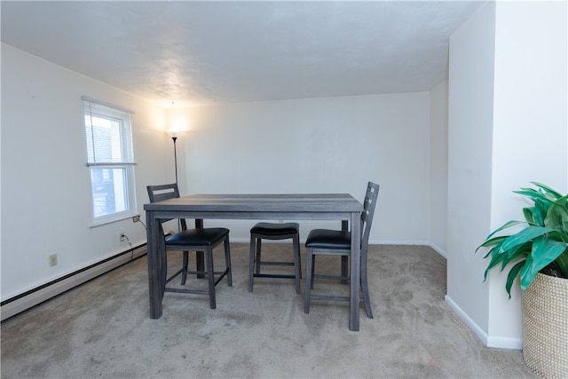 carpeted dining space with a baseboard radiator