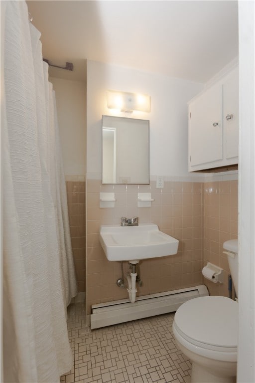 bathroom featuring sink, curtained shower, tile patterned floors, tile walls, and toilet