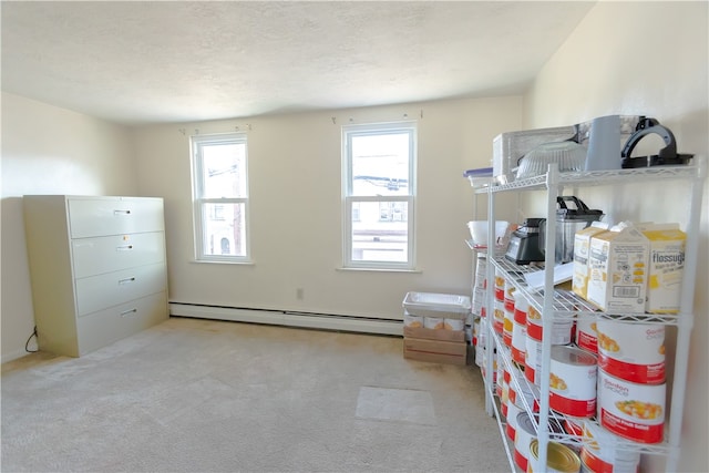 misc room with light colored carpet, a textured ceiling, and baseboard heating