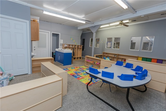 recreation room featuring carpet and ceiling fan