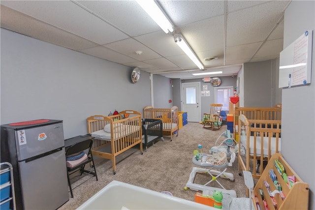 misc room featuring a drop ceiling and carpet