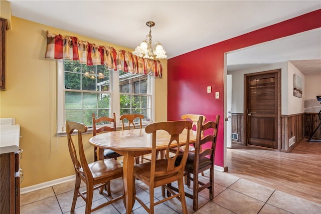 dining space featuring an inviting chandelier and light hardwood / wood-style floors