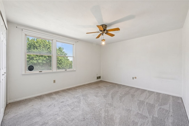 spare room with carpet floors and ceiling fan