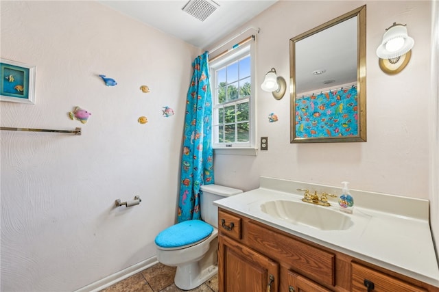 bathroom featuring vanity, tile patterned flooring, and toilet