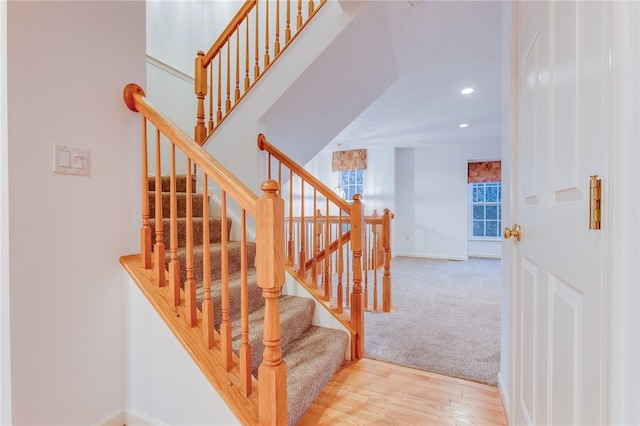 staircase with hardwood / wood-style flooring