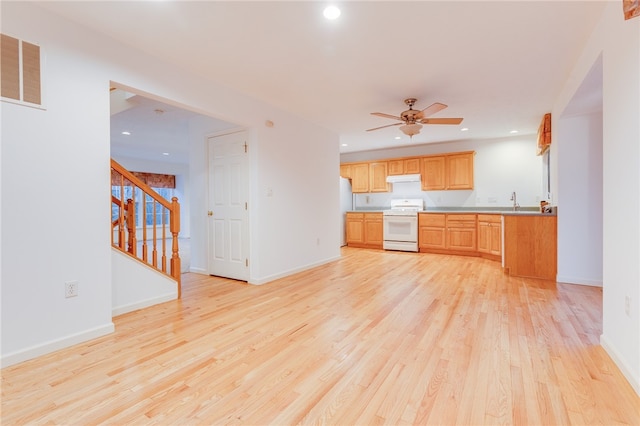 kitchen featuring ceiling fan, white appliances, sink, and light hardwood / wood-style flooring