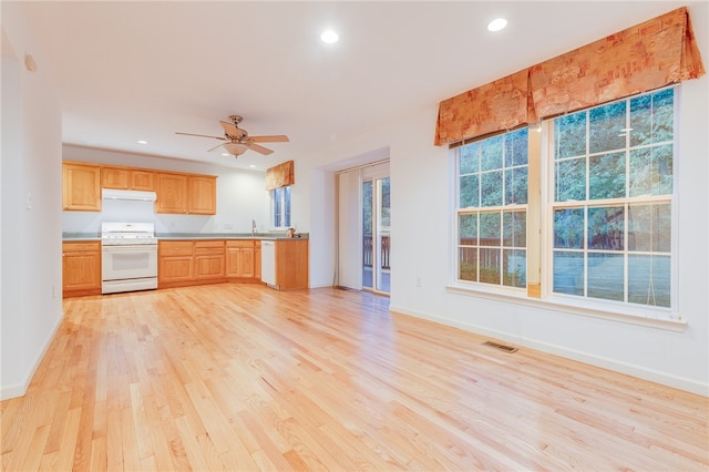 kitchen with light wood-type flooring, ceiling fan, white appliances, light brown cabinets, and sink