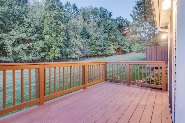 wooden terrace with a lawn