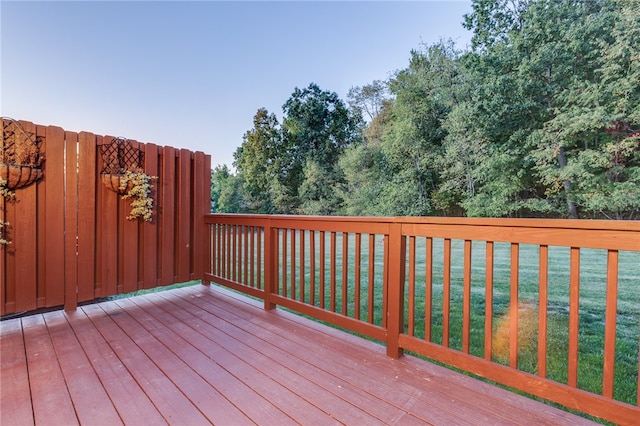 wooden terrace featuring a yard