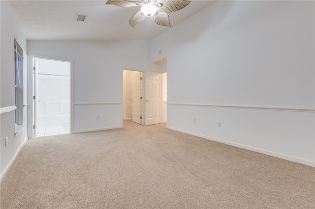 carpeted spare room with lofted ceiling and ceiling fan