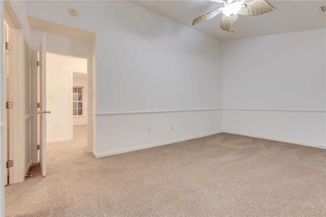 carpeted spare room featuring ceiling fan