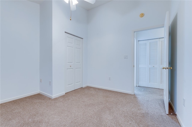 carpeted spare room with ceiling fan