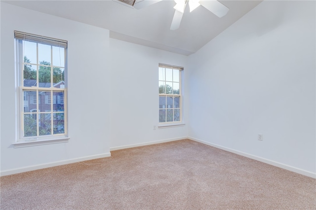 spare room with lofted ceiling, light colored carpet, and ceiling fan