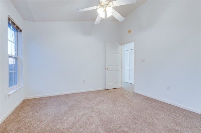 carpeted empty room with high vaulted ceiling and ceiling fan