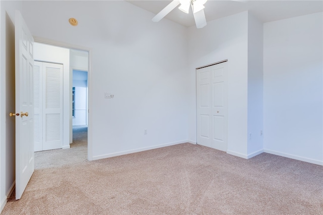 carpeted spare room with ceiling fan