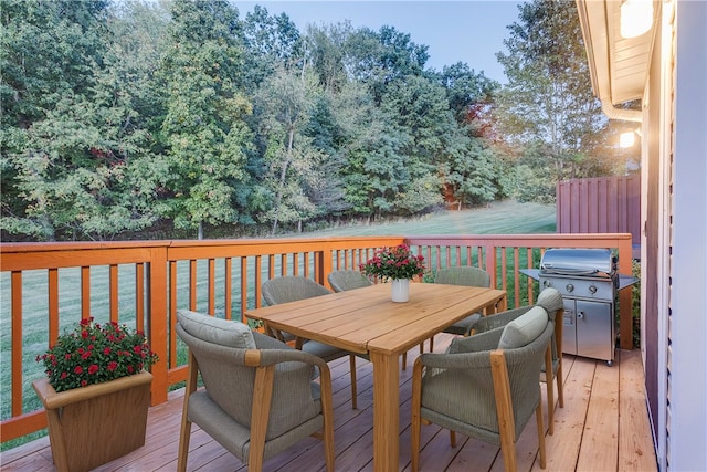 wooden terrace featuring a yard and grilling area